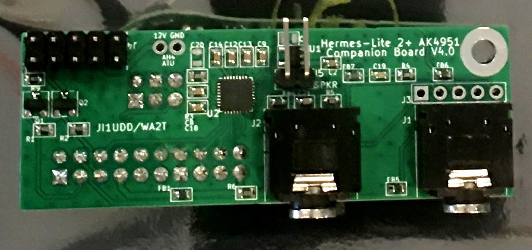 The AK4951 companion board, a small green PCB with two audio jacks