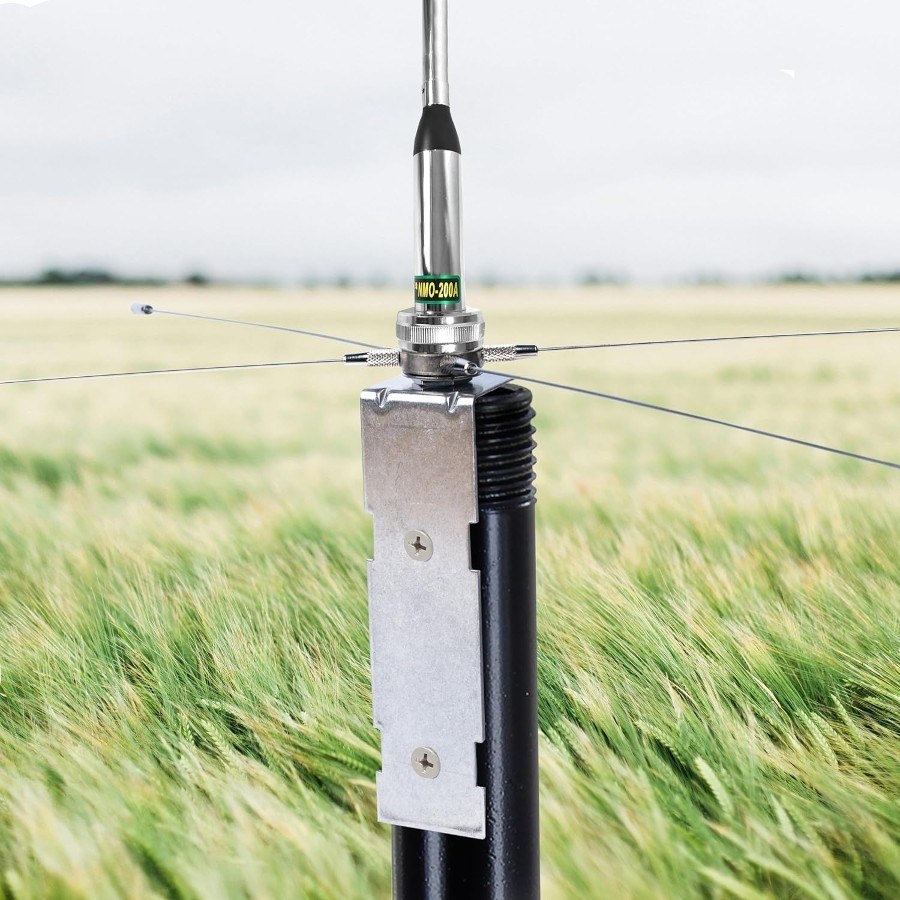 A radial kit mounted on a pole, its four horizontal radials supporting an NMO mobile whip antenna